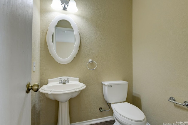 bathroom with toilet and a sink
