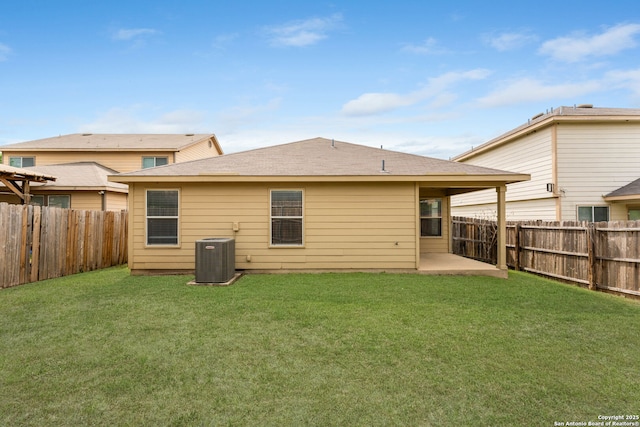 rear view of property with cooling unit, a yard, a patio area, and a fenced backyard