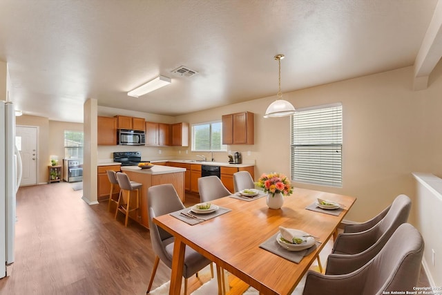 dining room with wood finished floors and visible vents