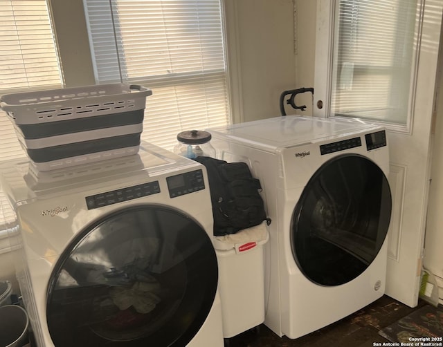 clothes washing area featuring washer and dryer and laundry area