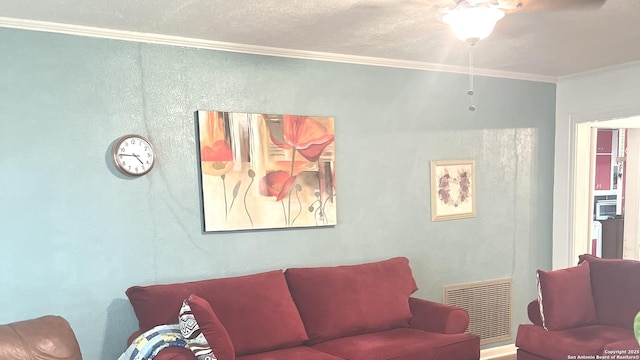 living room with visible vents and crown molding