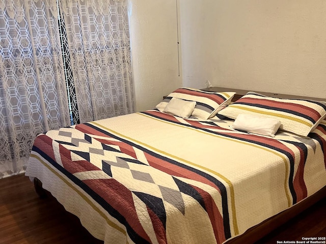 bedroom with wood finished floors