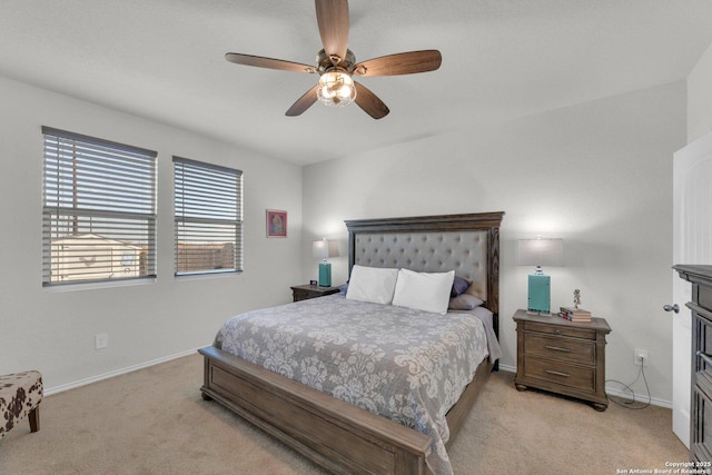 bedroom with ceiling fan, light carpet, and baseboards