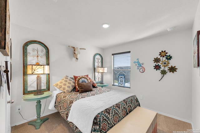 carpeted bedroom with baseboards