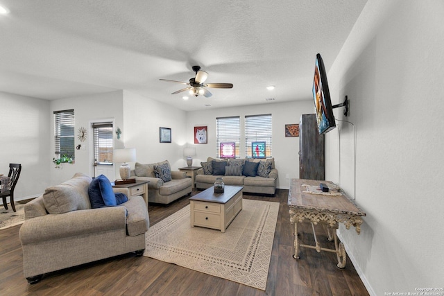 living area featuring dark wood-style floors, a textured ceiling, baseboards, recessed lighting, and a ceiling fan