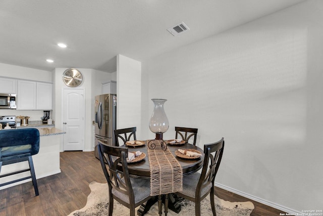 dining room featuring recessed lighting, dark wood finished floors, visible vents, and baseboards
