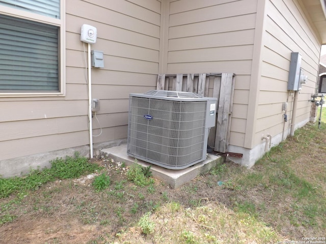 exterior details with electric meter and central AC unit