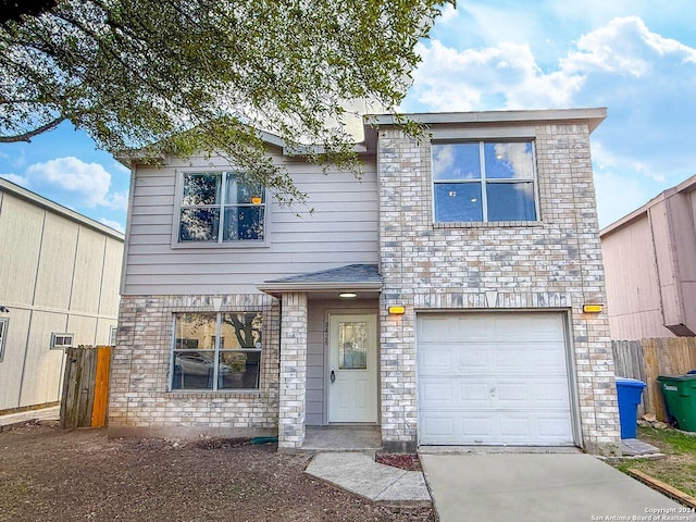 view of front of house with an attached garage, stone siding, and fence