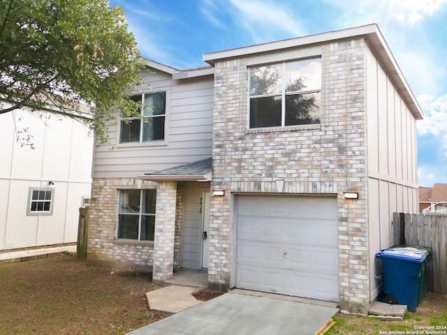 view of front of home with a garage, stone siding, concrete driveway, and fence