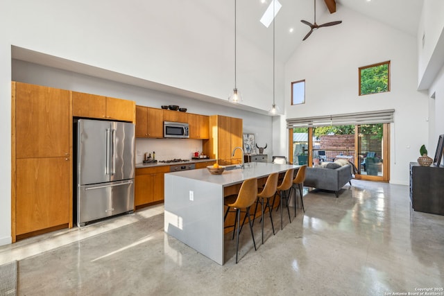 611 Simple Way, San Antonio, TX 78209 - kitchen with beamed ceiling, brown cabinets, ceiling fan, high vaulted ceiling, and appliances with stainless steel finishes