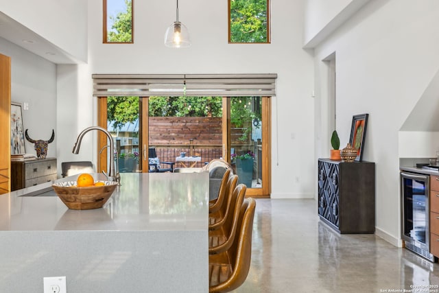 611 Simple Way, San Antonio, TX 78209 - dining room with concrete floors, a towering ceiling, and a wealth of natural light