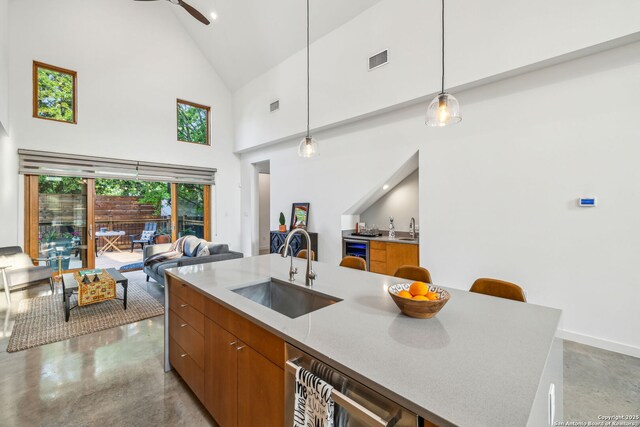 611 Simple Way, San Antonio, TX 78209 - kitchen featuring brown cabinets, visible vents, modern cabinets, a sink, and high vaulted ceiling