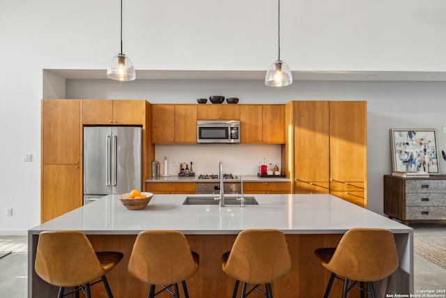611 Simple Way, San Antonio, TX 78209 - kitchen featuring light countertops, brown cabinetry, appliances with stainless steel finishes, and a sink