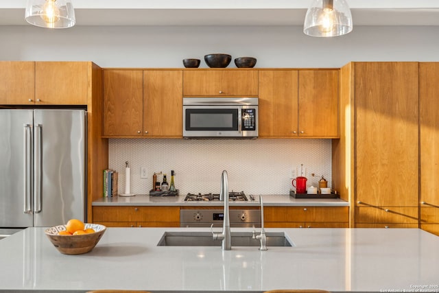 611 Simple Way, San Antonio, TX 78209 - kitchen with stainless steel appliances, a sink, backsplash, brown cabinetry, and light countertops