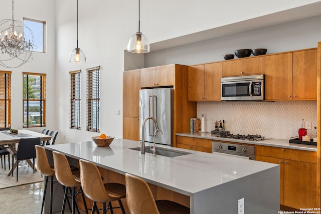 611 Simple Way, San Antonio, TX 78209 - kitchen with decorative backsplash, a wealth of natural light, stainless steel appliances, and a sink