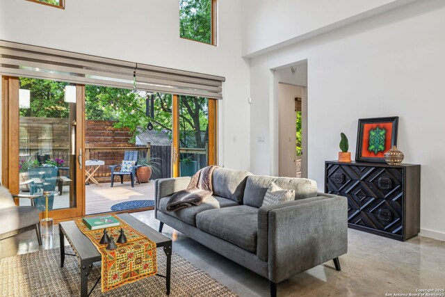 611 Simple Way, San Antonio, TX 78209 - living room featuring concrete flooring and a towering ceiling