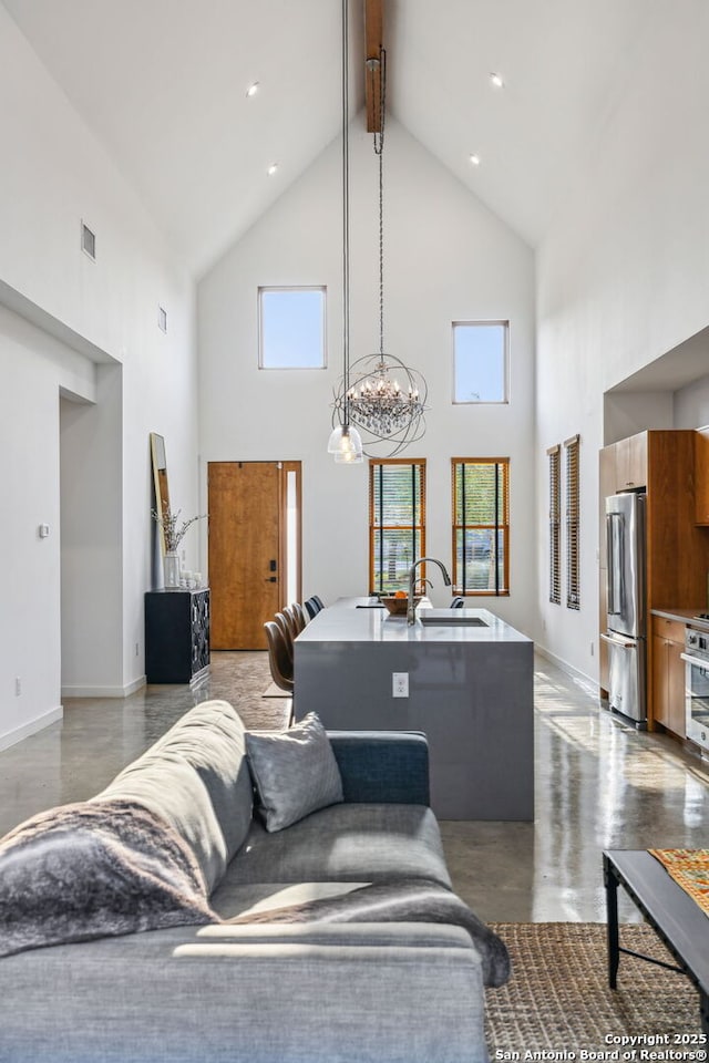 611 Simple Way, San Antonio, TX 78209 - living area featuring visible vents, concrete flooring, beam ceiling, baseboards, and high vaulted ceiling