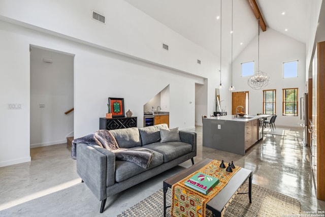 611 Simple Way, San Antonio, TX 78209 - living area featuring high vaulted ceiling, concrete flooring, beamed ceiling, baseboards, and a notable chandelier