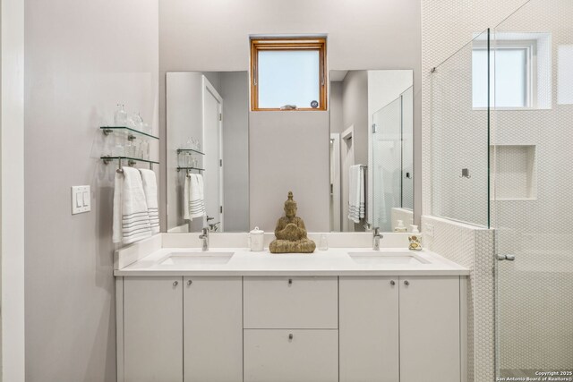 611 Simple Way, San Antonio, TX 78209 - full bath featuring a tile shower, double vanity, and a sink