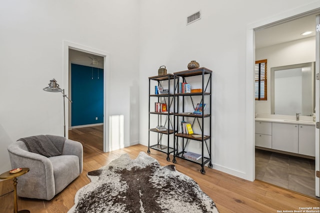 611 Simple Way, San Antonio, TX 78209 - sitting room with attic access, light wood-style flooring, and baseboards