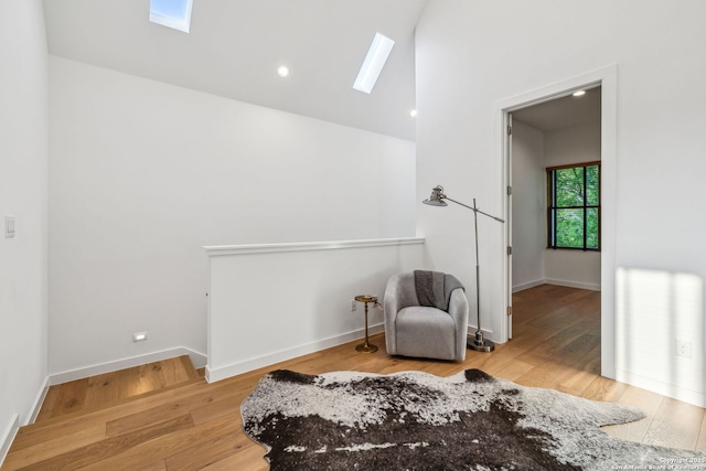 611 Simple Way, San Antonio, TX 78209 - sitting room with vaulted ceiling with skylight, wood finished floors, and baseboards