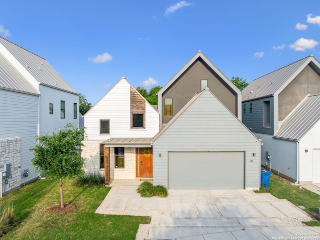 611 Simple Way, San Antonio, TX 78209 - view of front of home with a standing seam roof, stone siding, metal roof, concrete driveway, and an attached garage