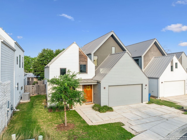 611 Simple Way, San Antonio, TX 78209 - view of front facade featuring a front lawn, driveway, metal roof, fence, and a garage