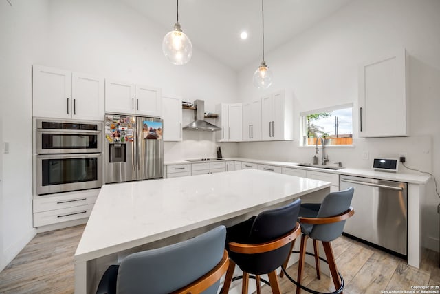 2114 Village, San Antonio, TX 78251 - kitchen featuring wall chimney exhaust hood, a sink, light countertops, high vaulted ceiling, and appliances with stainless steel finishes