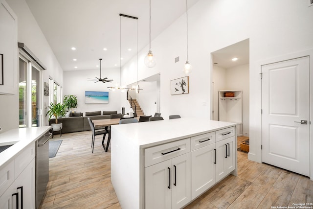 2114 Village, San Antonio, TX 78251 - kitchen with white cabinets, stainless steel dishwasher, light wood-type flooring, a ceiling fan, and light countertops