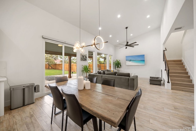 2114 Village, San Antonio, TX 78251 - dining area with stairway, high vaulted ceiling, ceiling fan with notable chandelier, light wood-style flooring, and visible vents