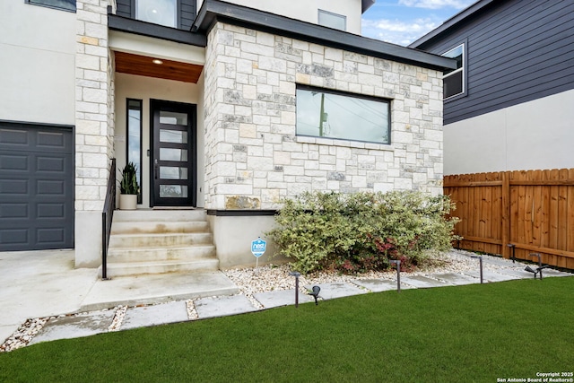 2114 Village, San Antonio, TX 78251 - view of exterior entry with a yard, fence, and stone siding