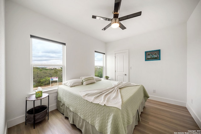 2114 Village, San Antonio, TX 78251 - bedroom with wood finished floors, baseboards, and ceiling fan