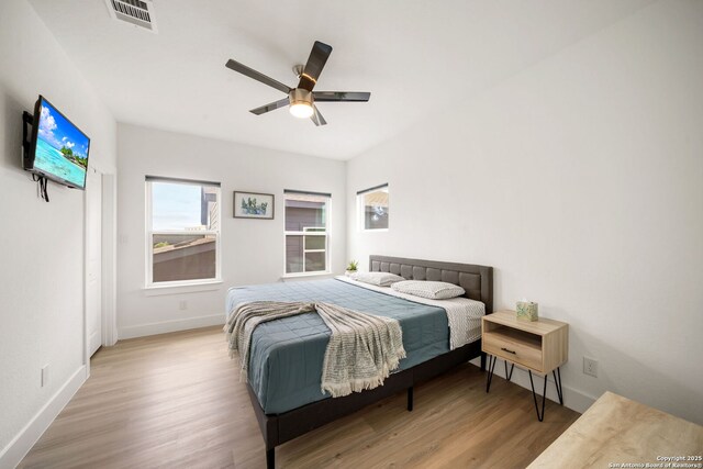 2114 Village, San Antonio, TX 78251 - bedroom with wood finished floors, visible vents, a ceiling fan, and baseboards