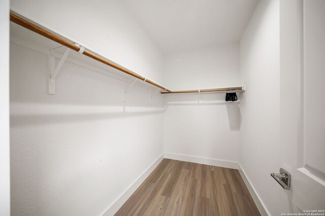 2114 Village, San Antonio, TX 78251 - spacious closet featuring light wood-style flooring