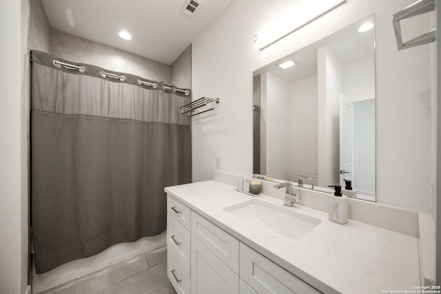 2114 Village, San Antonio, TX 78251 - full bath with tile patterned flooring, visible vents, toilet, vanity, and shower / bath combo with shower curtain