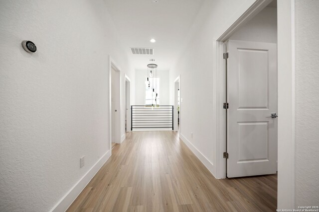 2114 Village, San Antonio, TX 78251 - corridor with baseboards, a textured wall, light wood finished floors, and visible vents