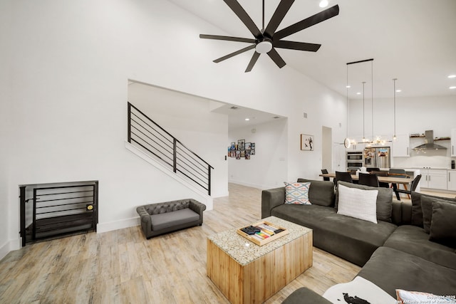 2114 Village, San Antonio, TX 78251 - living area with high vaulted ceiling, stairs, ceiling fan with notable chandelier, light wood-type flooring, and recessed lighting