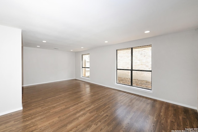empty room with baseboards, recessed lighting, and wood finished floors