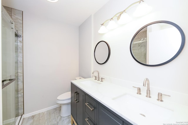 full bath with a stall shower, marble finish floor, and a sink