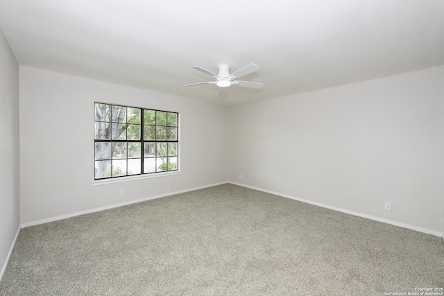 spare room with ceiling fan, carpet flooring, and baseboards
