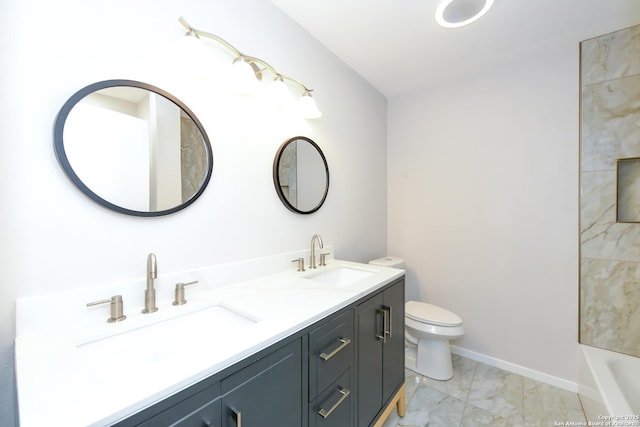 bathroom featuring a tub to relax in, toilet, marble finish floor, and a sink