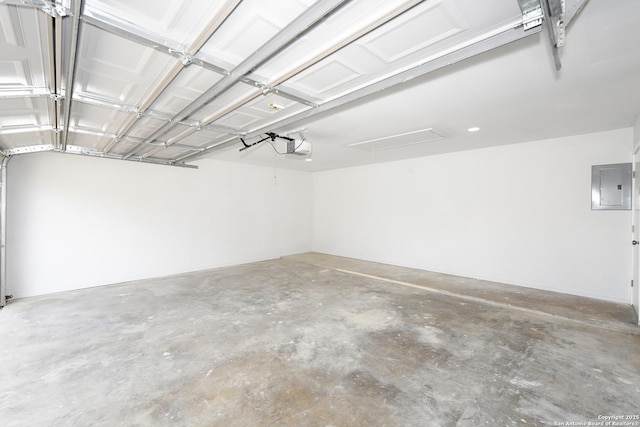 garage with a garage door opener and electric panel