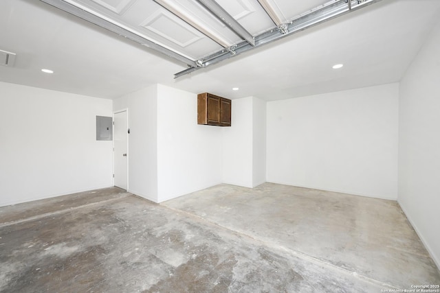 garage with recessed lighting and electric panel
