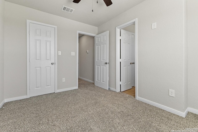 unfurnished bedroom featuring carpet floors, visible vents, and baseboards