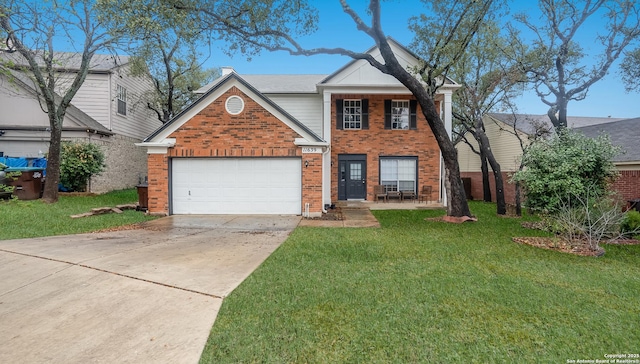 traditional-style home with driveway, a front lawn, brick siding, and a garage