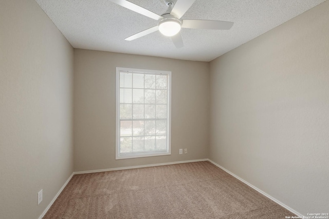 unfurnished room featuring baseboards, a ceiling fan, carpet flooring, and a textured ceiling