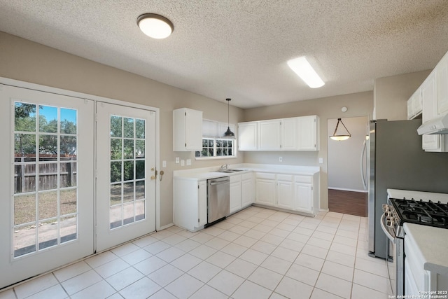 kitchen with appliances with stainless steel finishes, a sink, white cabinetry, and light countertops