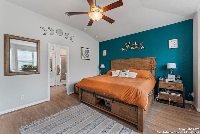 bedroom featuring wood finished floors, ceiling fan, baseboards, lofted ceiling, and visible vents