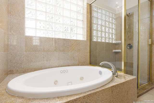 full bathroom featuring a shower stall and a whirlpool tub