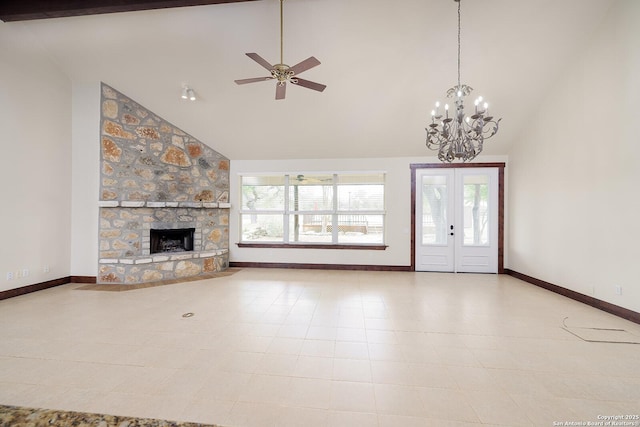 unfurnished living room featuring high vaulted ceiling, baseboards, and plenty of natural light